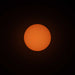 A photo of the sun, taken with ES-FLAR80640CF-iEXOS-100, showing the orange-colored sun with sunspots scattered across the visible surface of the sun